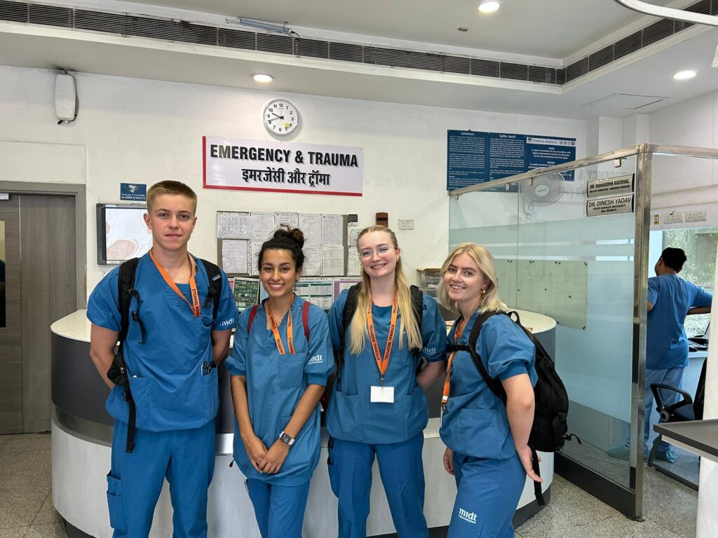 healthcare interns posing infront of emergency room