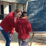 kids learning from volunteer in India