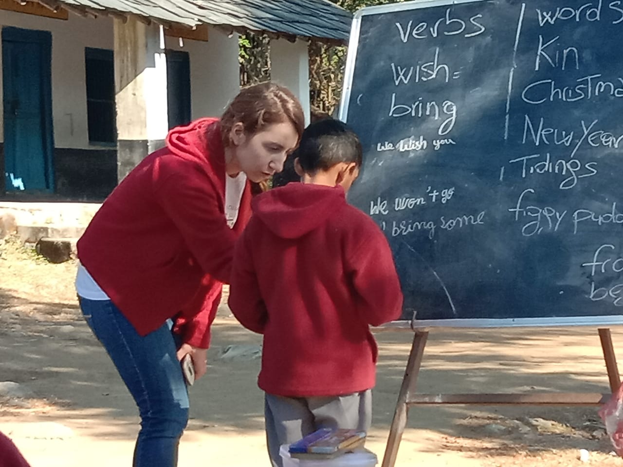 kids learning from volunteer in India